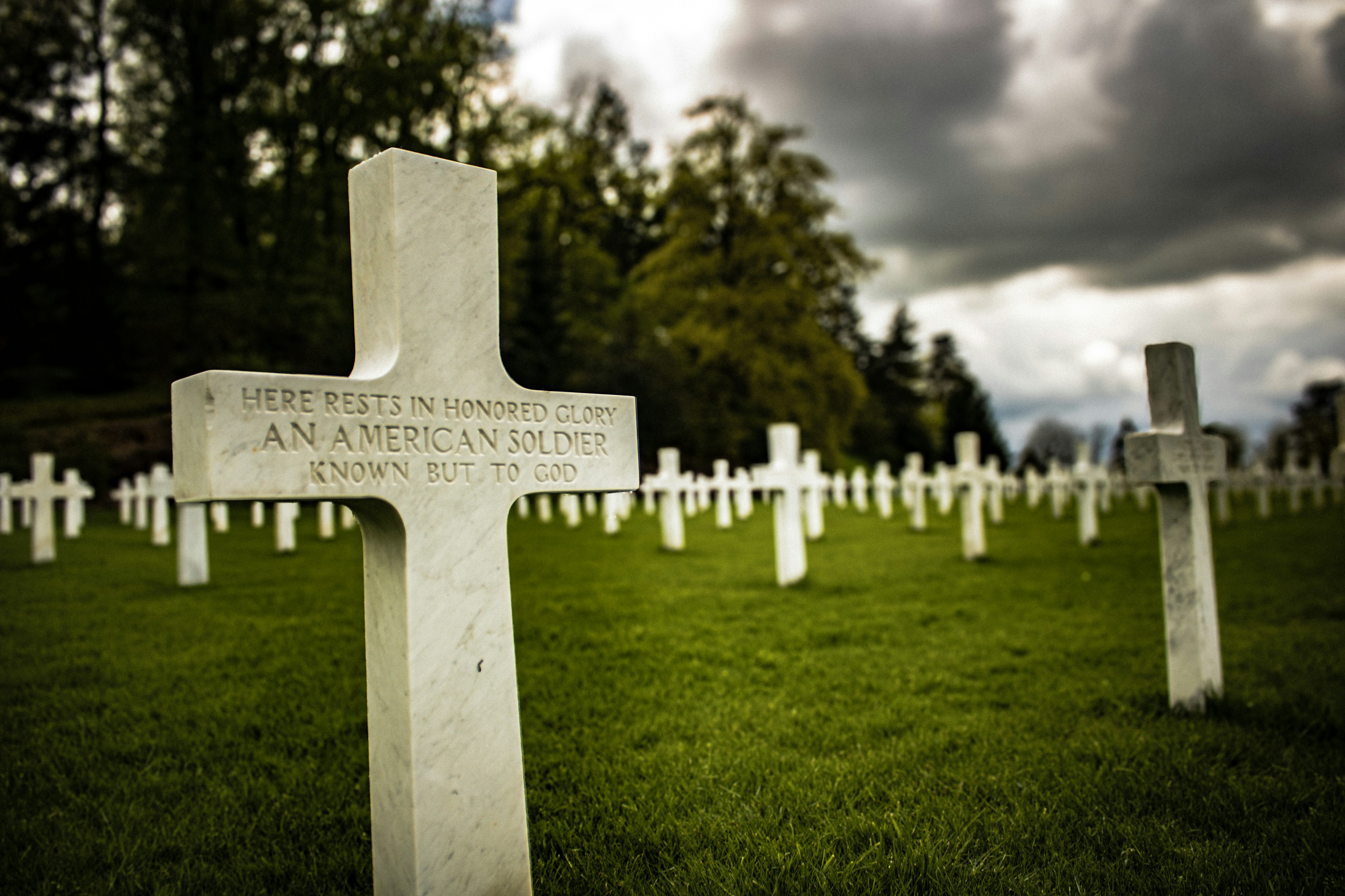 a cemetery with many headstones and crosses