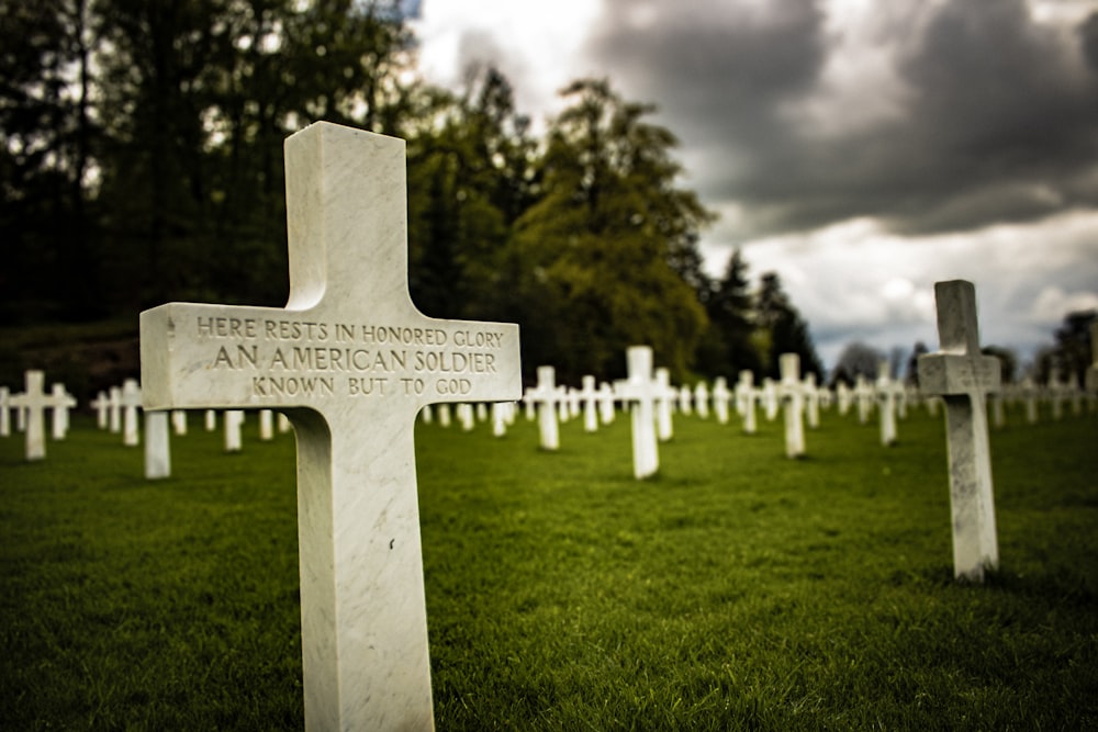 a cemetery with many headstones and crosses