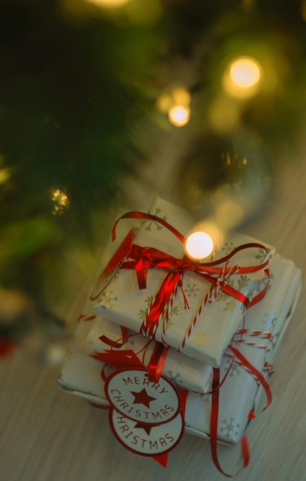 a stack of wrapped presents sitting on top of a table