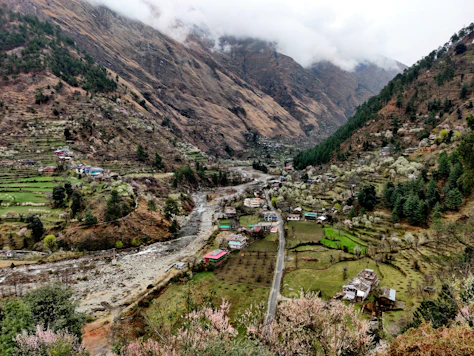 a village in the middle of a valley surrounded by mountains