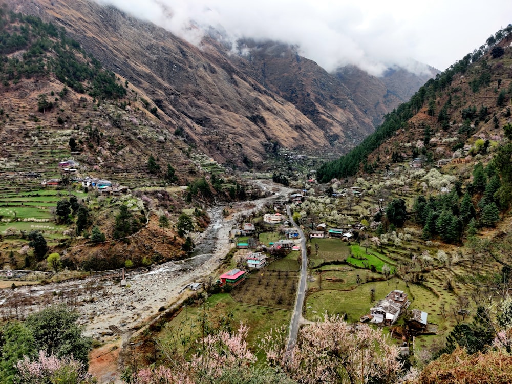 a village in the middle of a valley surrounded by mountains