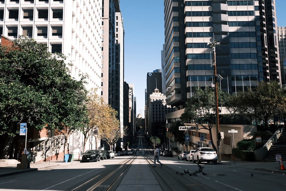 a view of a city street with a train on the tracks