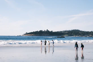 Guests enjoying a peaceful walk along the sandy Puri sea beach at sunrise.