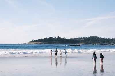 Participants walking along the shoreline, enjoying a relaxing beach walk as part of the activity.