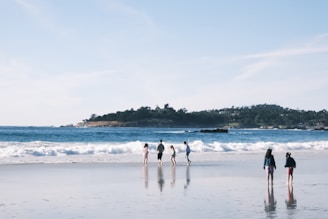 Guests enjoying a morning walk along the sandy beach near the hotel.