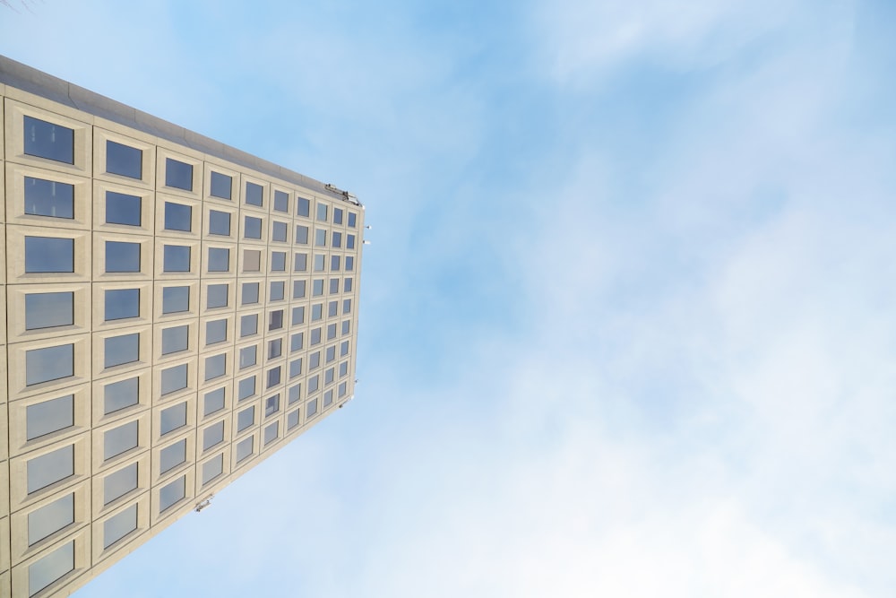 a tall building with lots of windows against a blue sky