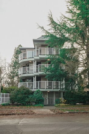 A freshly renovated affordable apartment building with welcoming entrances and green landscaping.