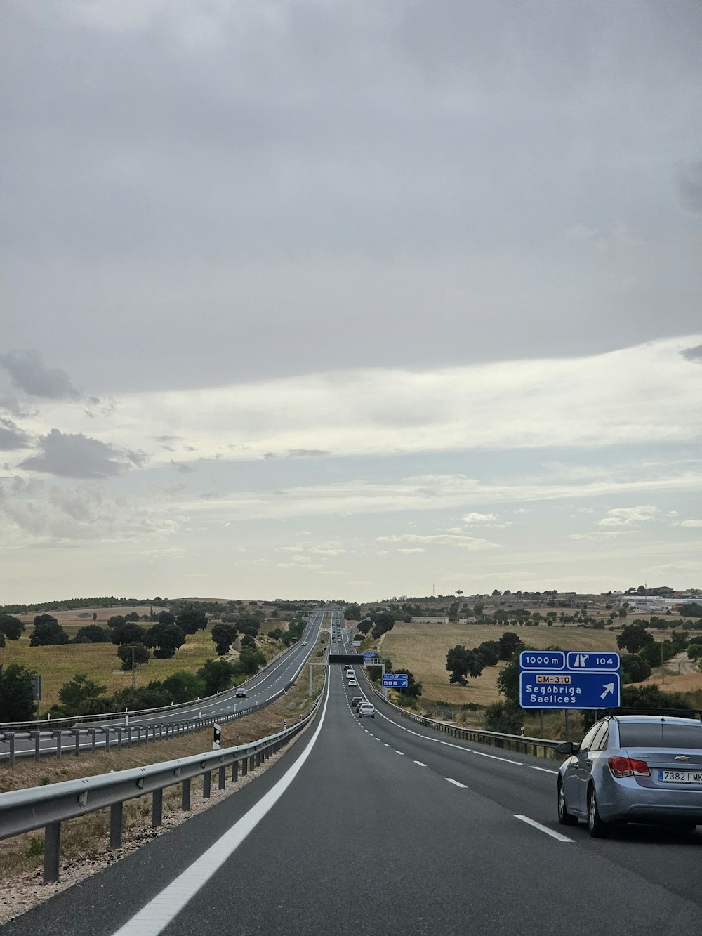 a car driving down a highway next to a highway sign