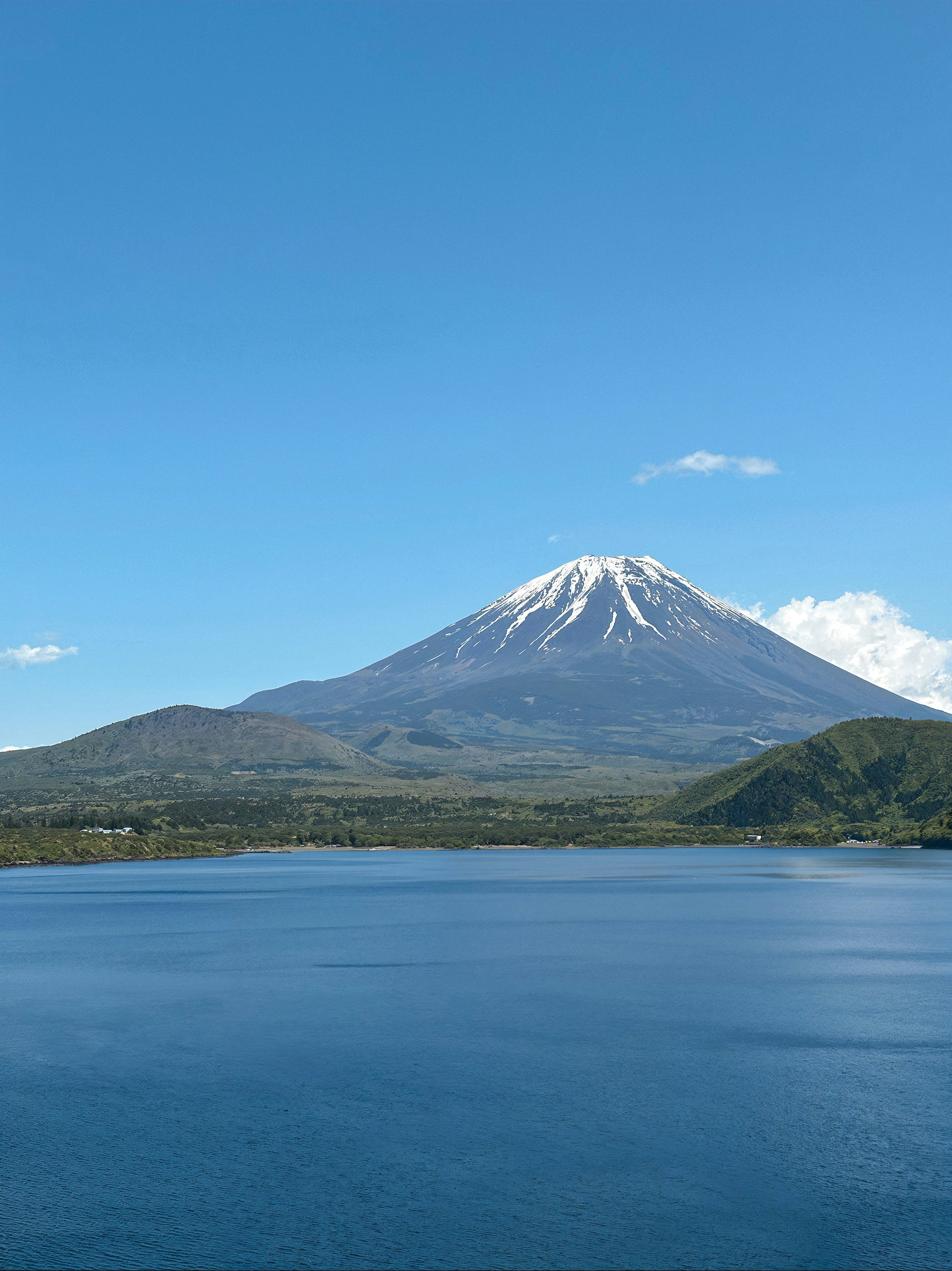 a large body of water with a mountain in the background
