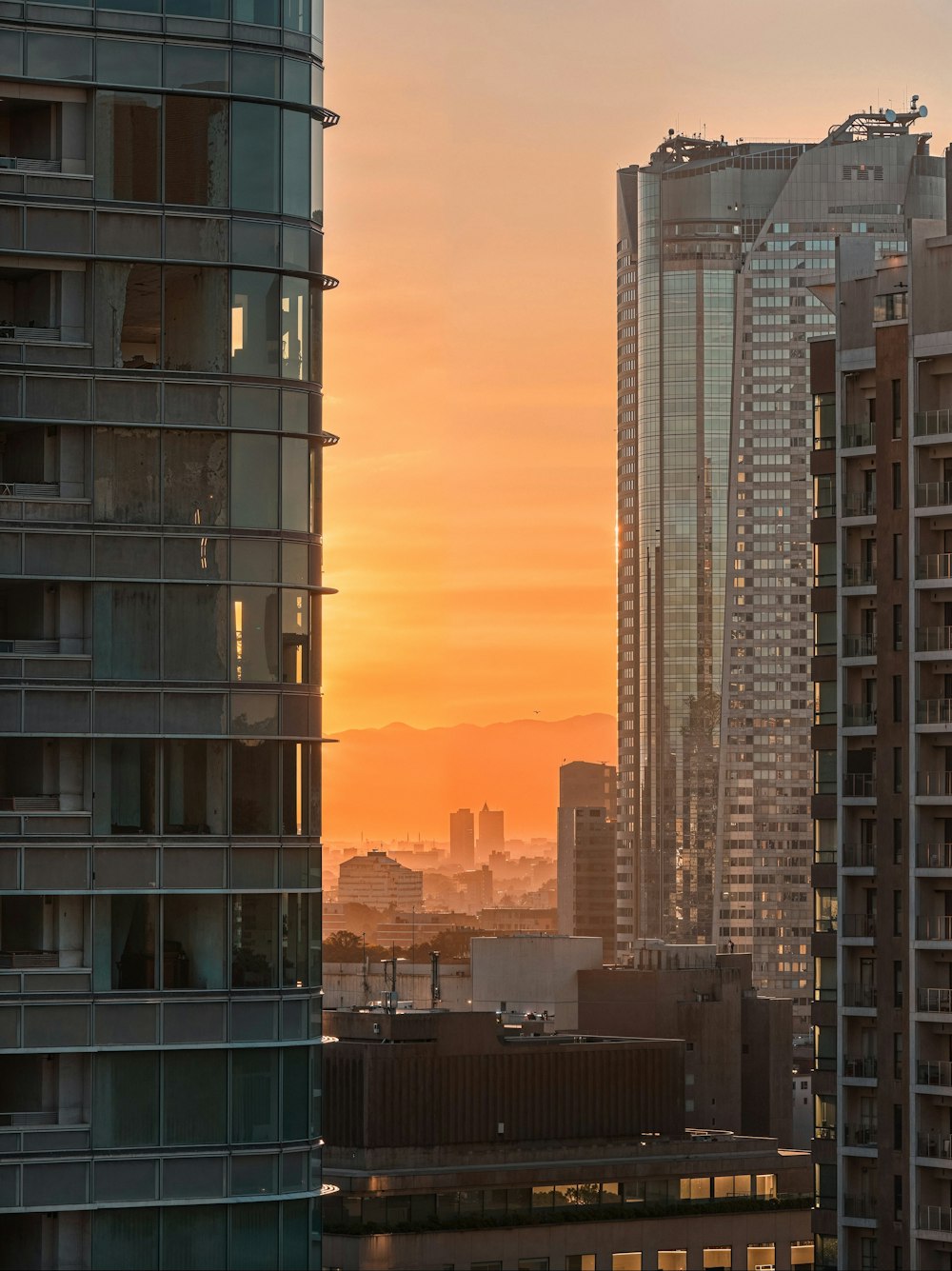 a view of a city at sunset from a high rise building