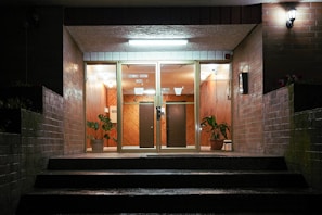 A well-lit entrance of a condominium with security features.