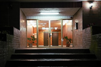 A well-lit entrance of a condominium with security features.
