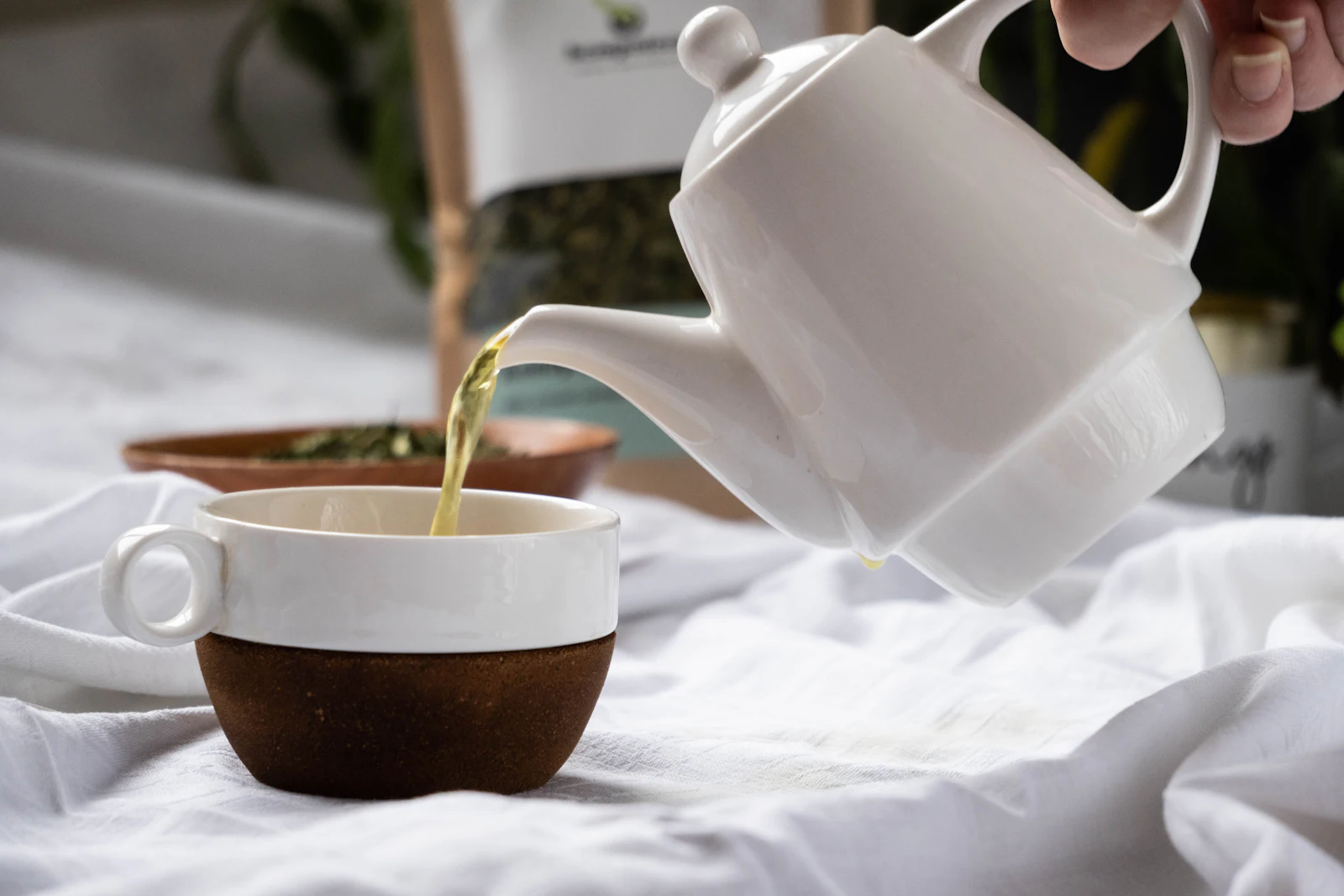 Green tea being poured into a cup