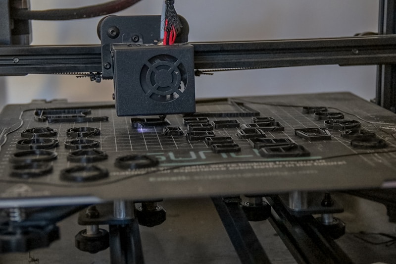 3D printing workspace with various printed models and tools