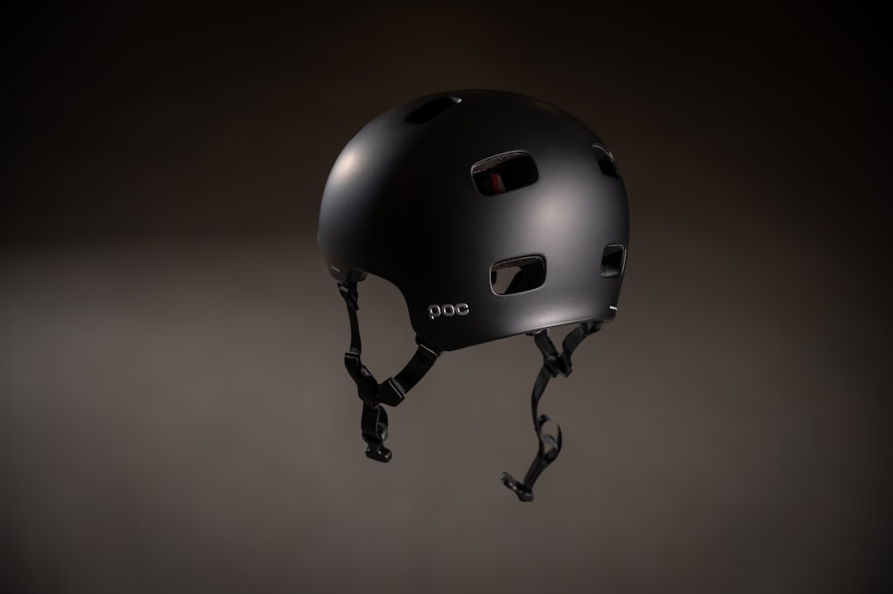 a black helmet is hanging upside down