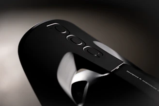 Close-up of a sleek black and gray POC radio device on a desk.