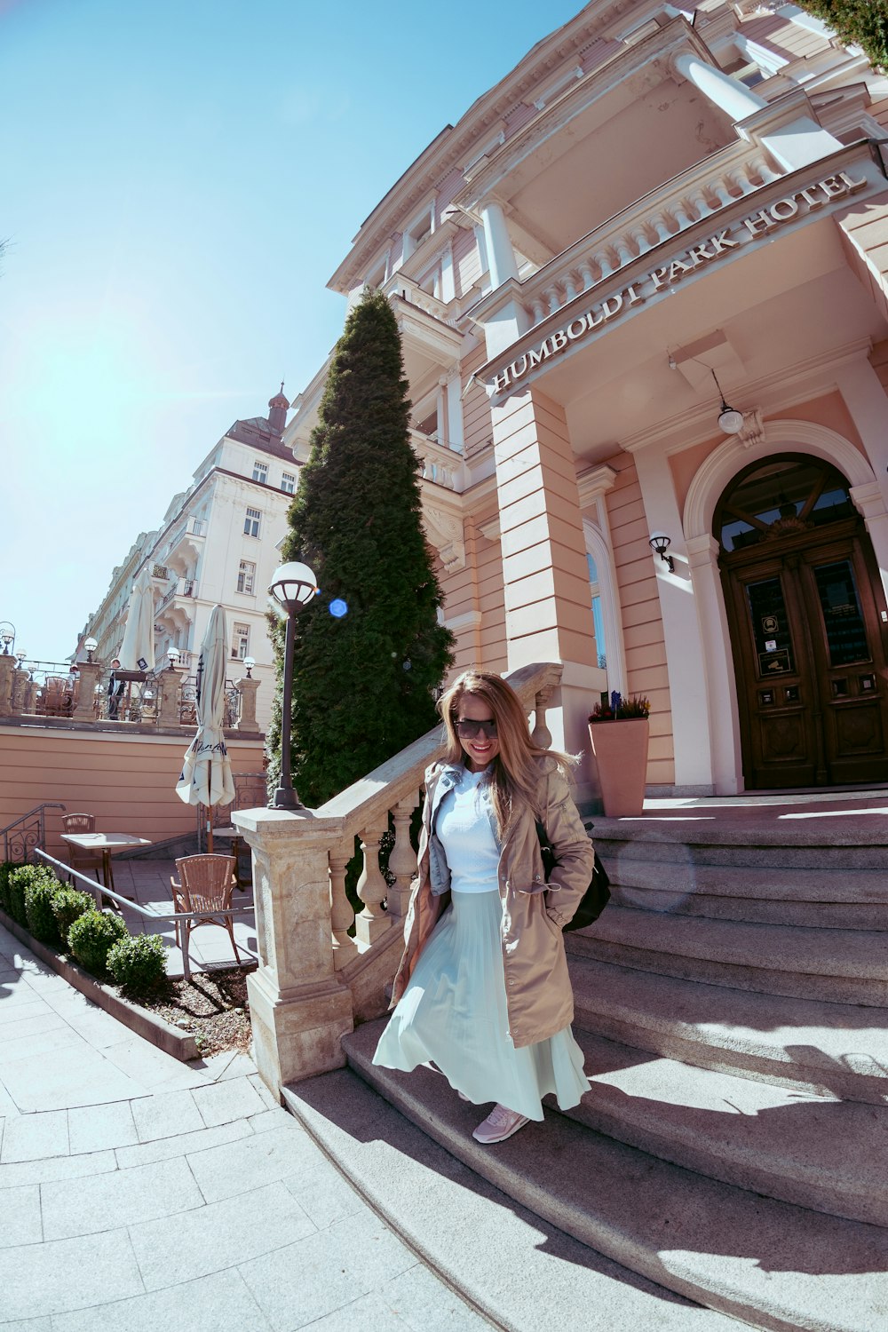 a woman standing on the steps of a building