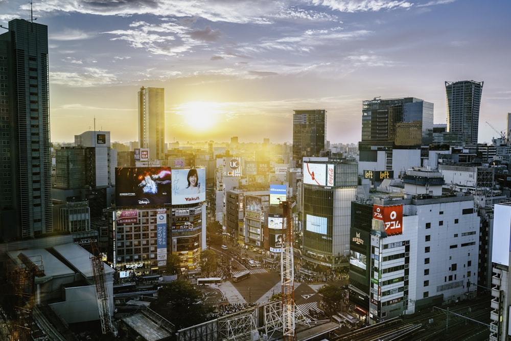 a cityscape with a sunset in the background