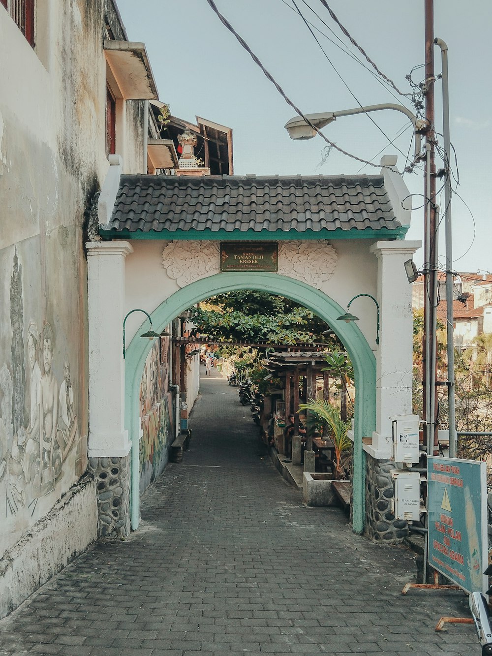 an archway leading to a building with graffiti on it