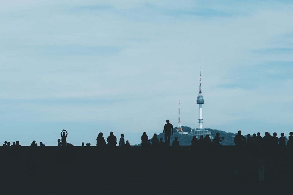 a group of people standing on top of a hill