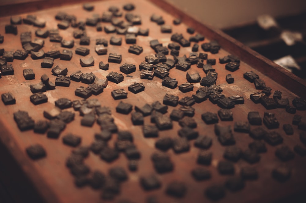 a wooden table topped with lots of chocolate pieces