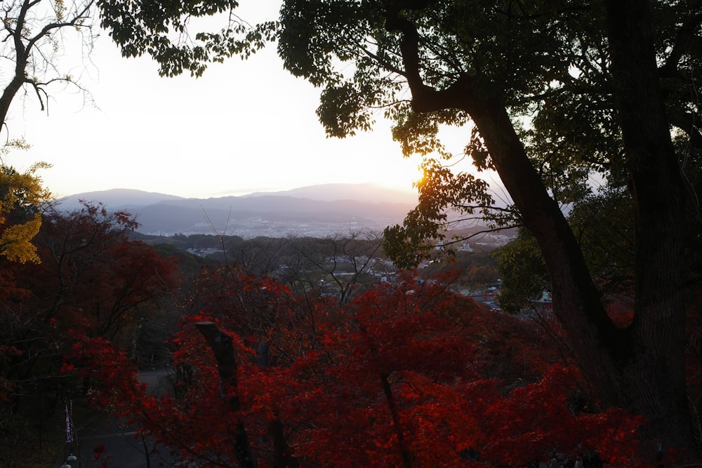 the sun is setting over the mountains in the distance