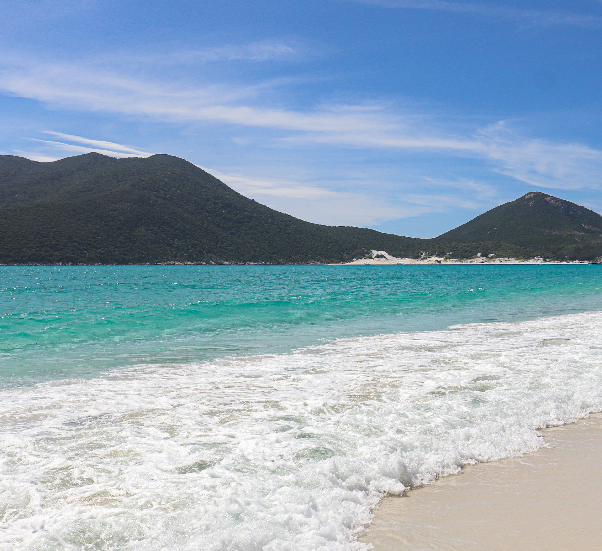 a person riding a surfboard on the beach
