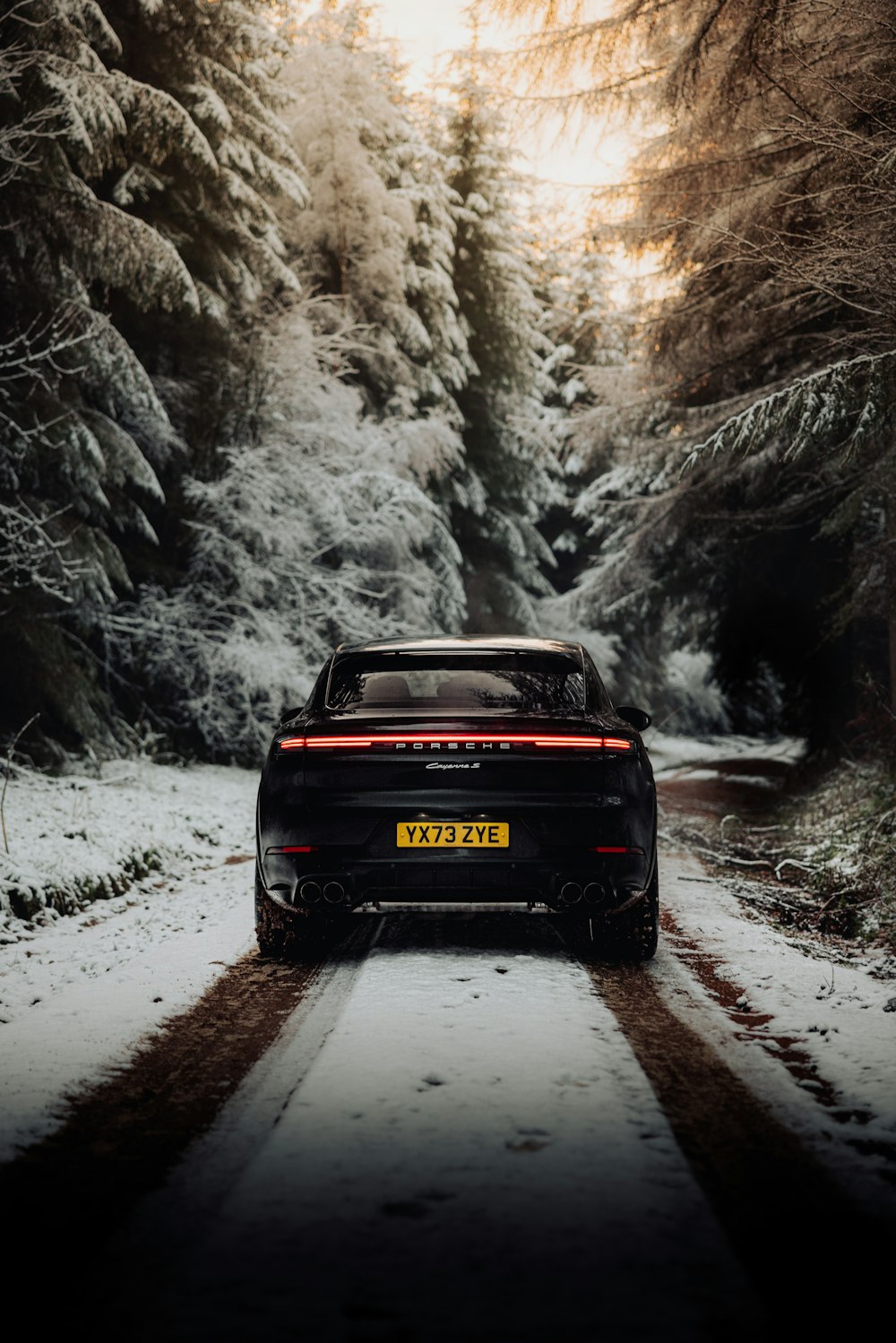 a car is driving down a snowy road