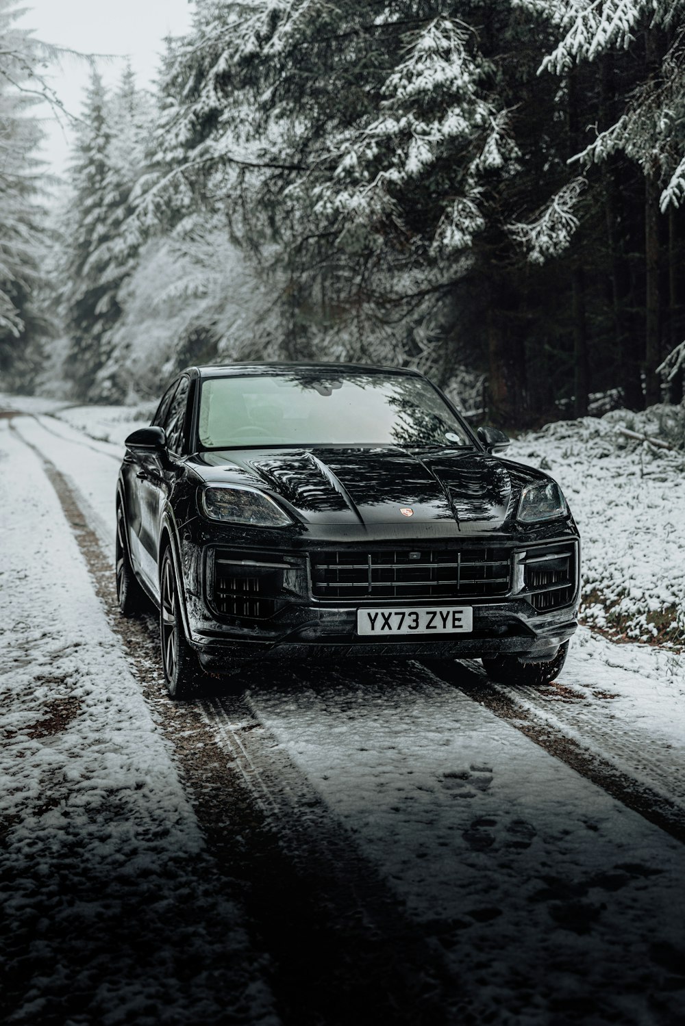 a car driving down a snow covered road