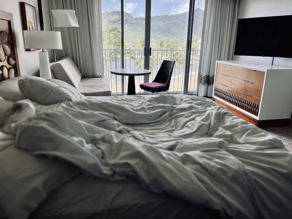 a bedroom with a large bed and a balcony