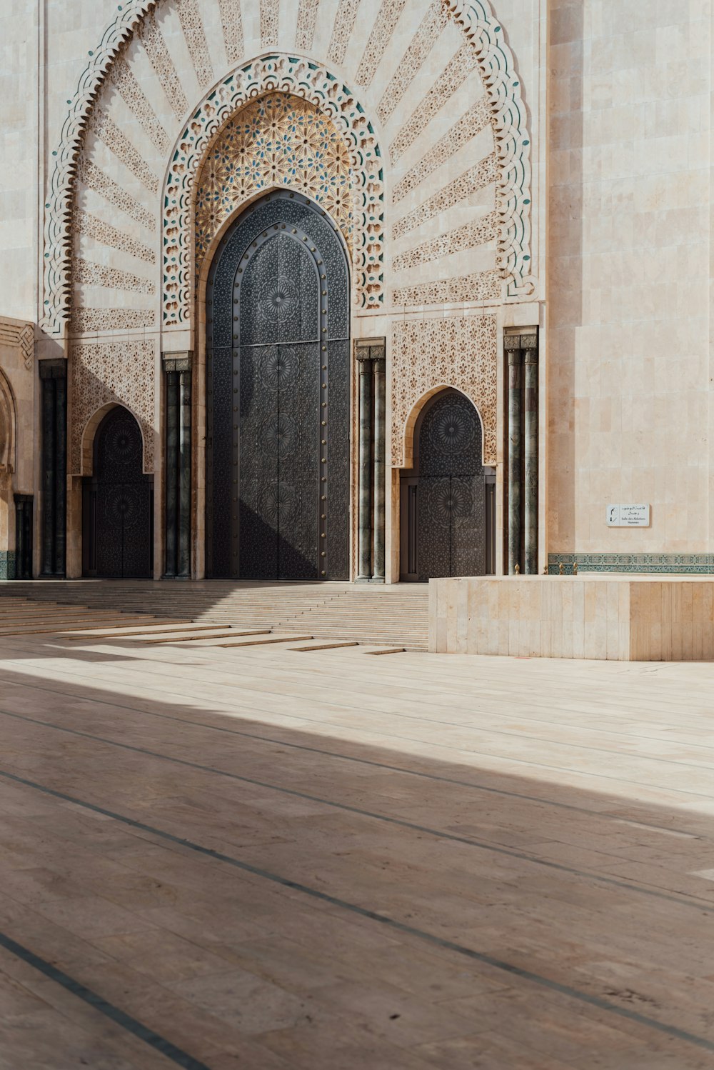 a building with a large black door and a wooden floor