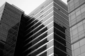 a black and white photo of two tall buildings