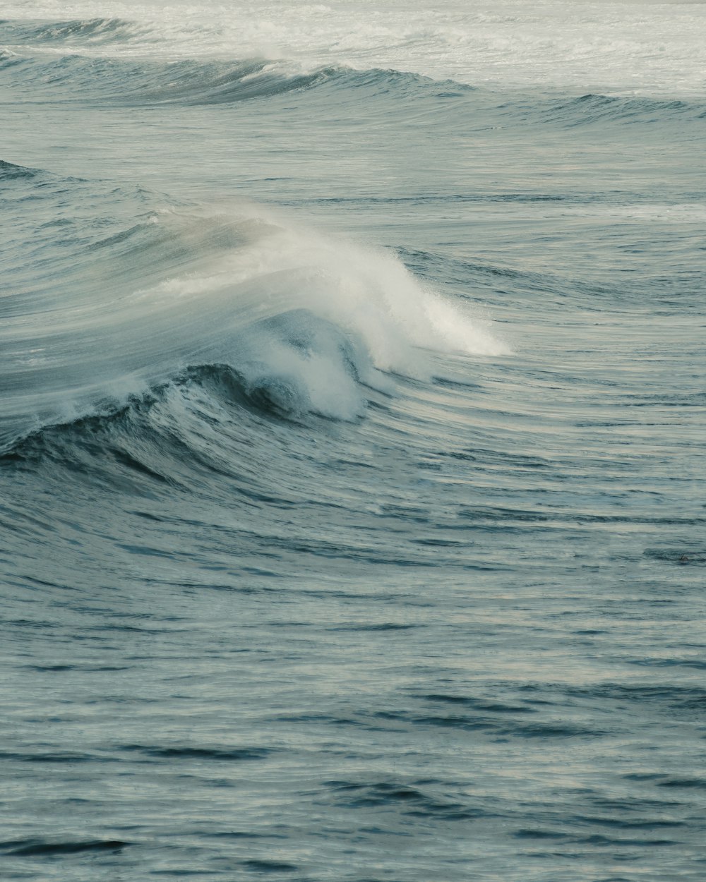 a person riding a surfboard on a wave in the ocean