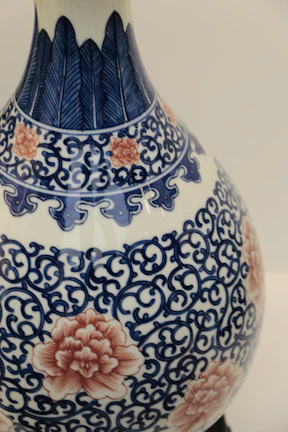 A close-up of a hand-painted ceramic vase with intricate designs.