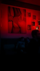 An intimate art mediation session with engaged audience in a dimly lit room.