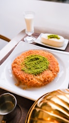 Traditional Turkish kadayıf desserts topped with creamy kaymak and walnuts.