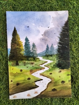 A watercolor painting of a serene landscape with a winding stream flowing through a grassy field. Tall evergreen trees line the sides, and the sky is lightly clouded with birds flying above.