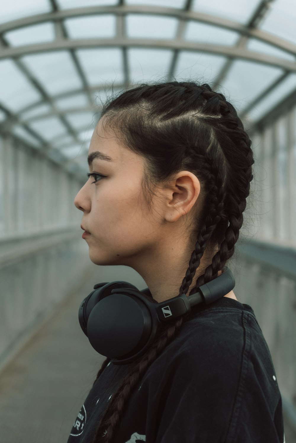 a young woman with braids wearing headphones