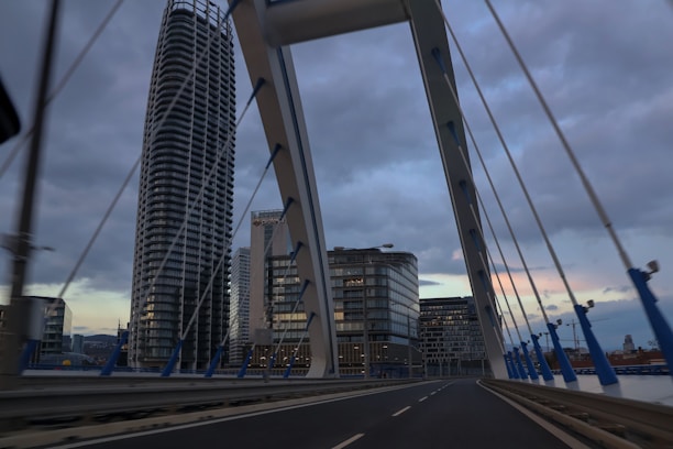 a view of a bridge with buildings in the background