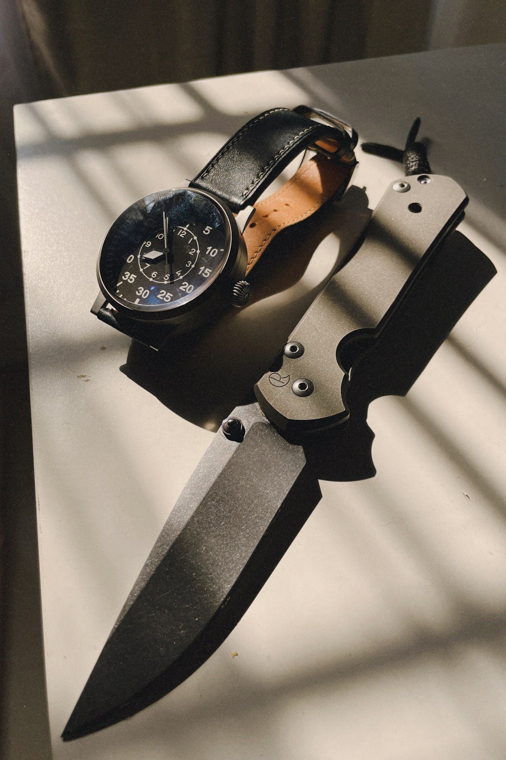 a knife and a watch on a table