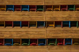 Public space seating area featuring colorful, hand-painted wooden furniture.
