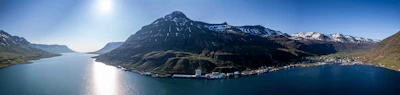 A panoramic view of the fjords in Norway under a clear blue sky
