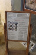 A teacher explaining Russian art vocabulary using colorful paintings.