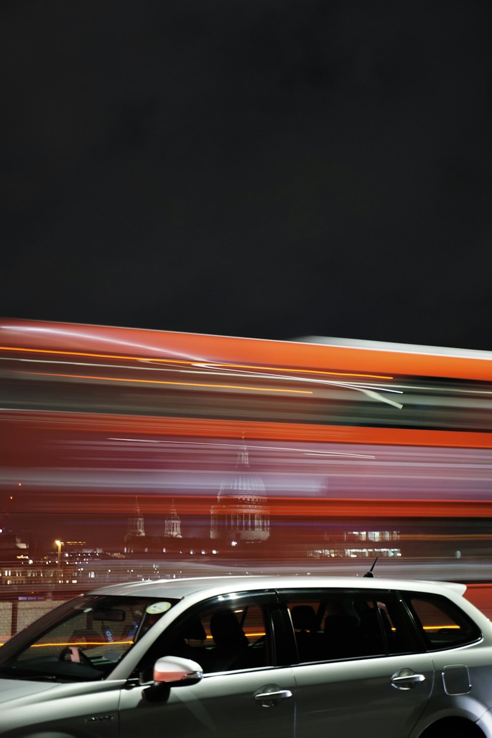 a car driving down a street at night