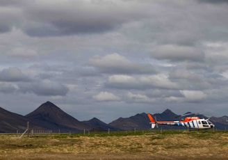 a small plane is parked on a grassy field