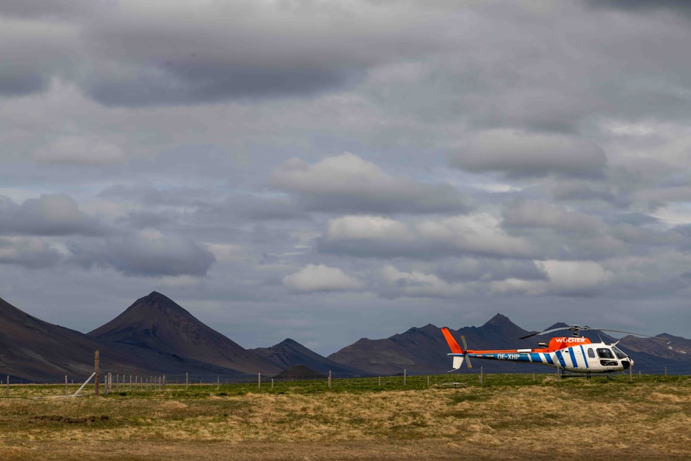 a small plane is parked on a grassy field