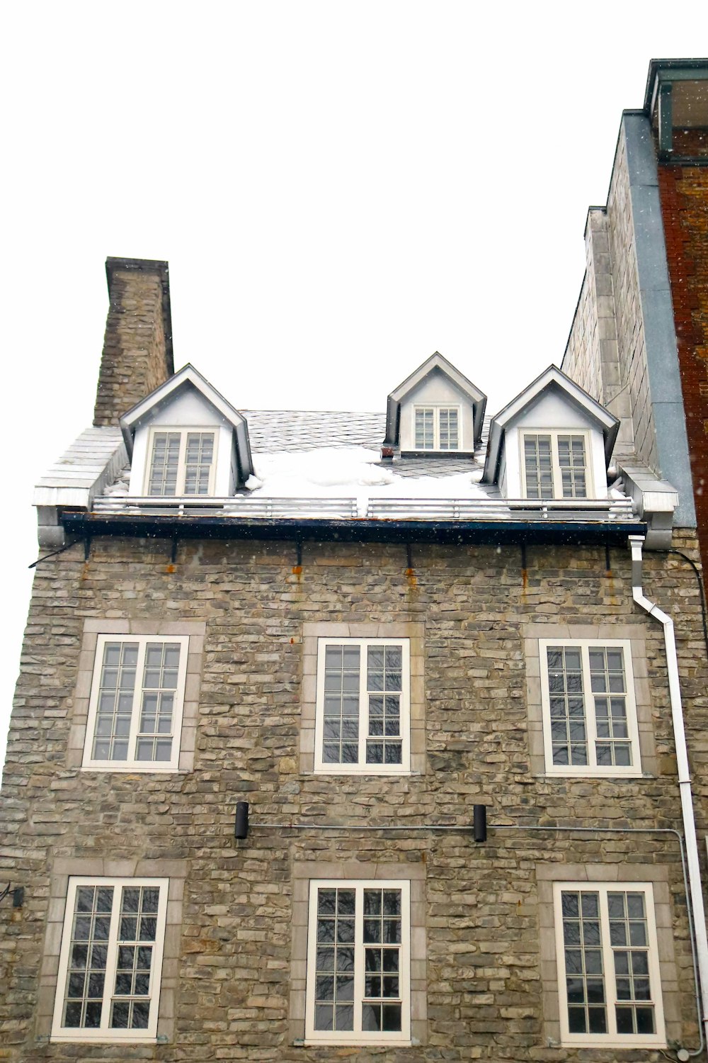 a tall brick building with a clock on the front of it