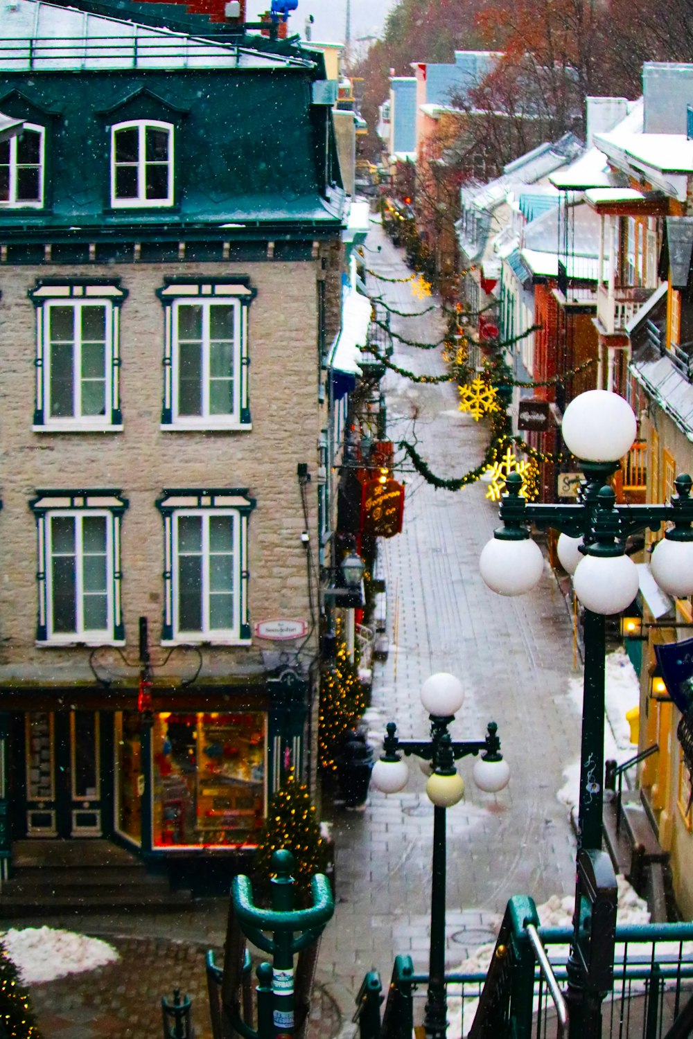 a view of a city street with christmas lights