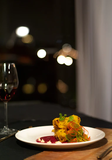 Close-up of an elegant plate of gourmet food with fresh, colorful ingredients arranged artfully.