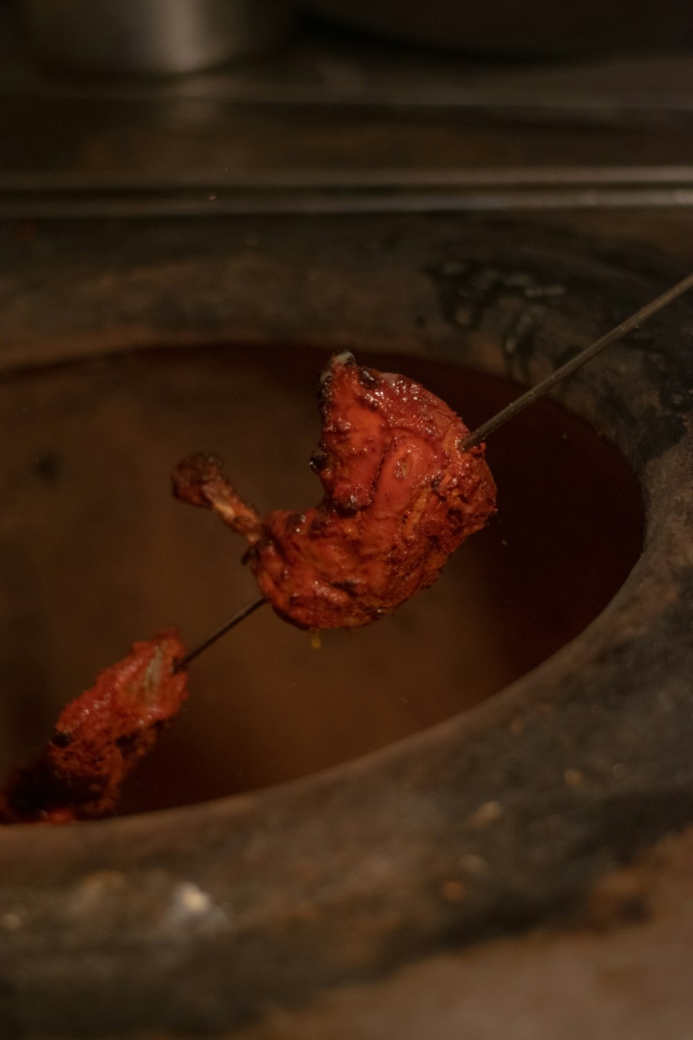 a piece of meat is being cooked in a pot